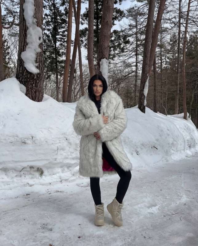 White Faux Fur Coat with Black Leggings and Winter Boots - Image 1